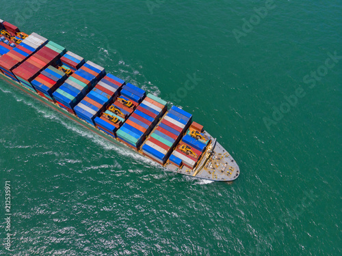 Container ship in export and import business and logistics in the ocean. Water transport International. Aerial view