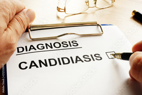 Doctor is holding form with Candidiasis. photo