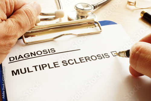 Man is holding clipboard with multiple sclerosis.