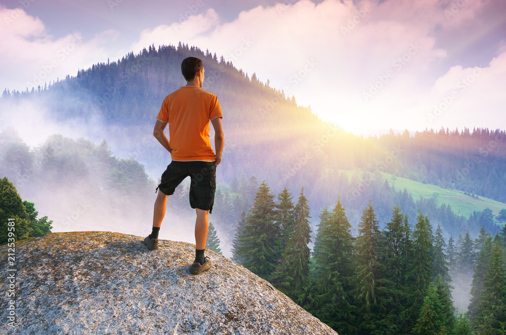 Man on peak of mountain