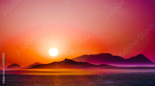 View on purple sunrise over the mountains in the desert