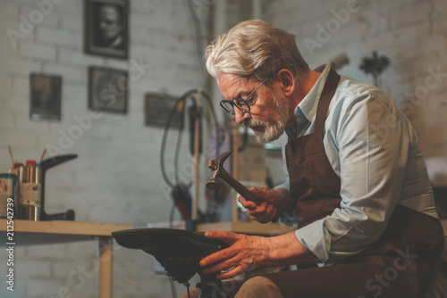 An elderly man in a workshop photo
