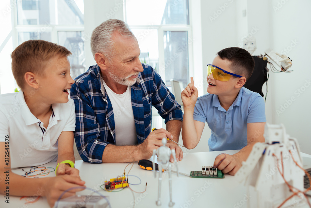 Brilliant solution. Nice smart boy looking at his teacher while sharing his idea Brilliant solution. Nice smart boy looking at his teacher while sharing his idea