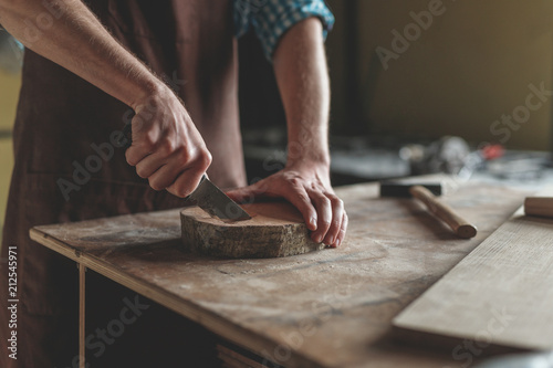 Men's hands with wood