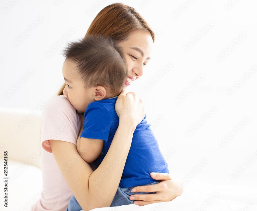 Close Up Of Mother Cuddling Baby son At Home Close Up Of Mother Cuddling Baby son At Home