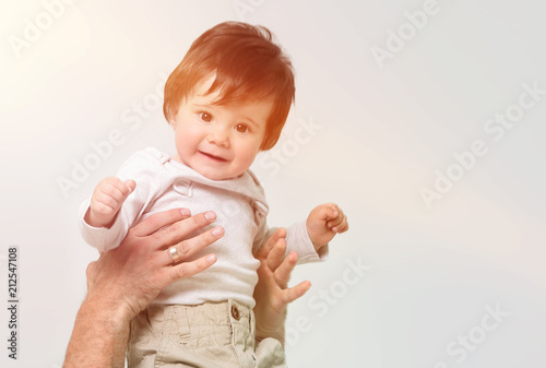 Father throws his laughing son in the air