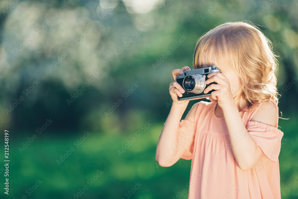 Little girl with a retro camera