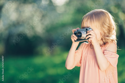 Little girl with a retro camera