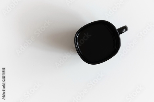 Сoffee cup on white table background. Flat lay, top view, copy space 