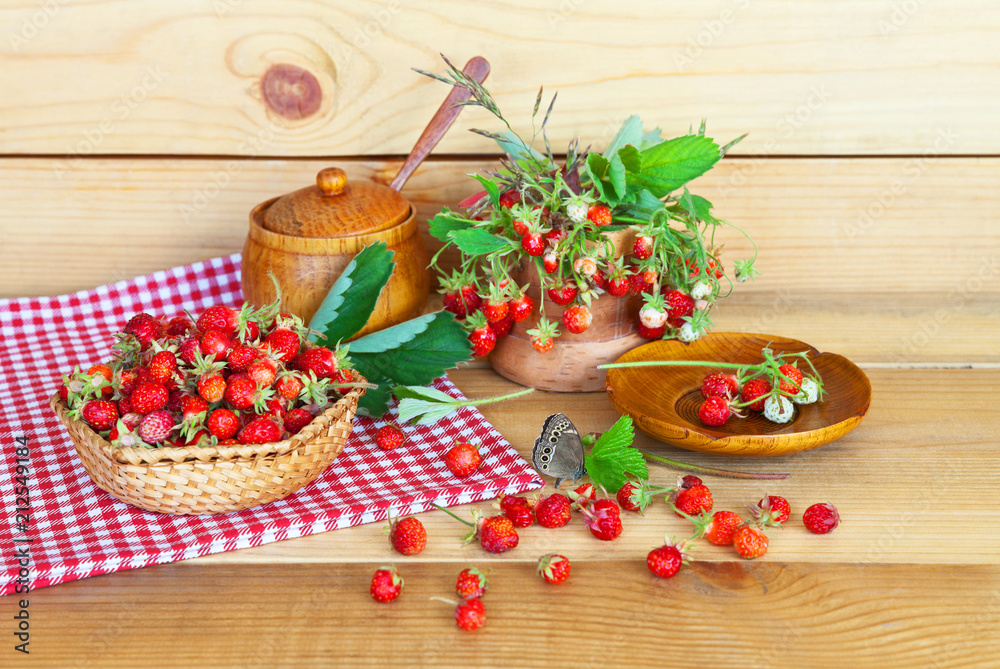 Summer still life with strawberry on a wooden background in a rustic style Summer still life with strawberry on a wooden background in a rustic style