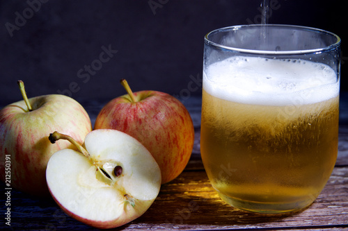 Three apples and a glass of cider