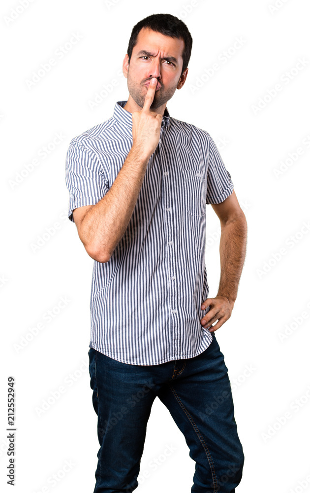 Handsome man making horn gesture on isolated white background Handsome man making horn gesture on isolated white background
