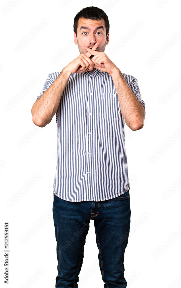 Handsome man making silence gesture on isolated white background Handsome man making silence gesture on isolated white background