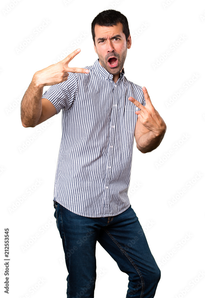 Fototapeta premium Handsome man making victory gesture on isolated white background