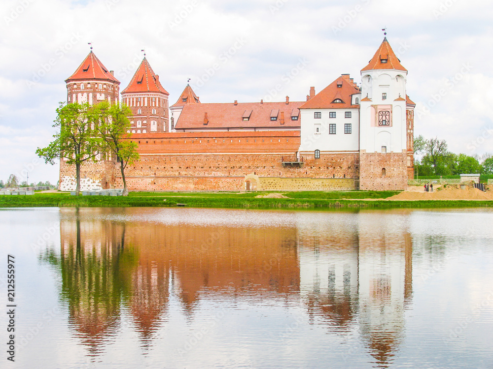 Mir, Belarus. Castle Complex Mir On Sunny Day with blue sky Background. Old medieval Towers and walls of traditional fort from unesco world heritage list Mir, Belarus. Castle Complex Mir On Sunny Day with blue sky Background. Old medieval Towers and walls of traditional fort from unesco world heritage list
