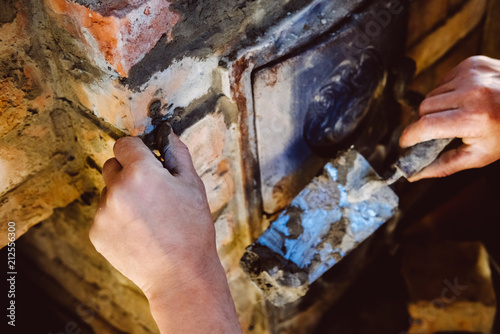 Restoration repair of the old village furnace. Bricklaying.