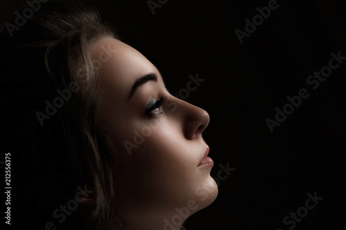 Beauty Woman with Perfect Makeup.silhouette of a female face on a black background. Side view