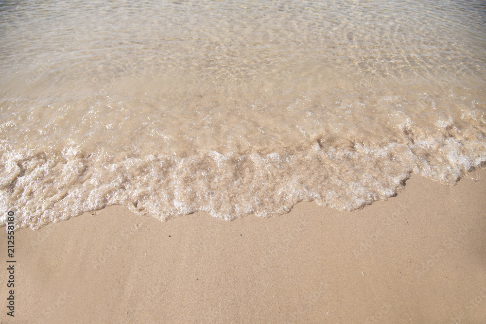 Soft waves on sandy beach