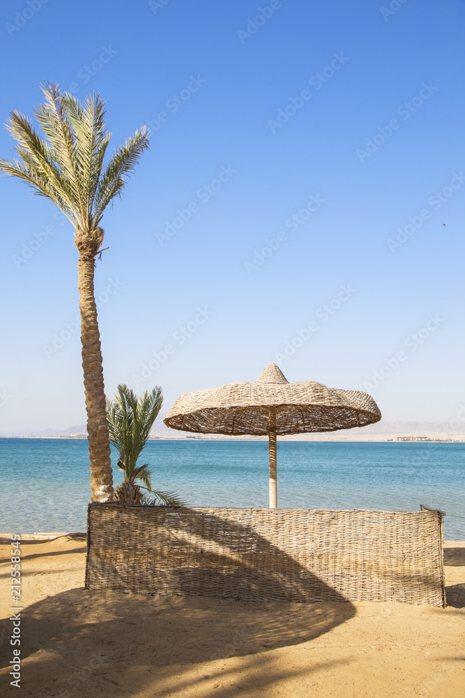 Straw umbrella on tropical beach Straw umbrella on tropical beach