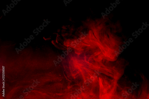 Red smoke isolated on black background.