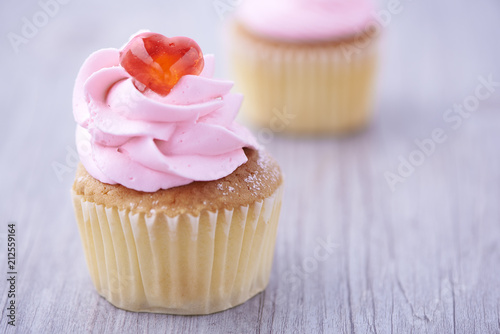 Two cupcakes on wooden background