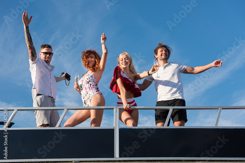 Freinds are having fun on yacht under the blue sky