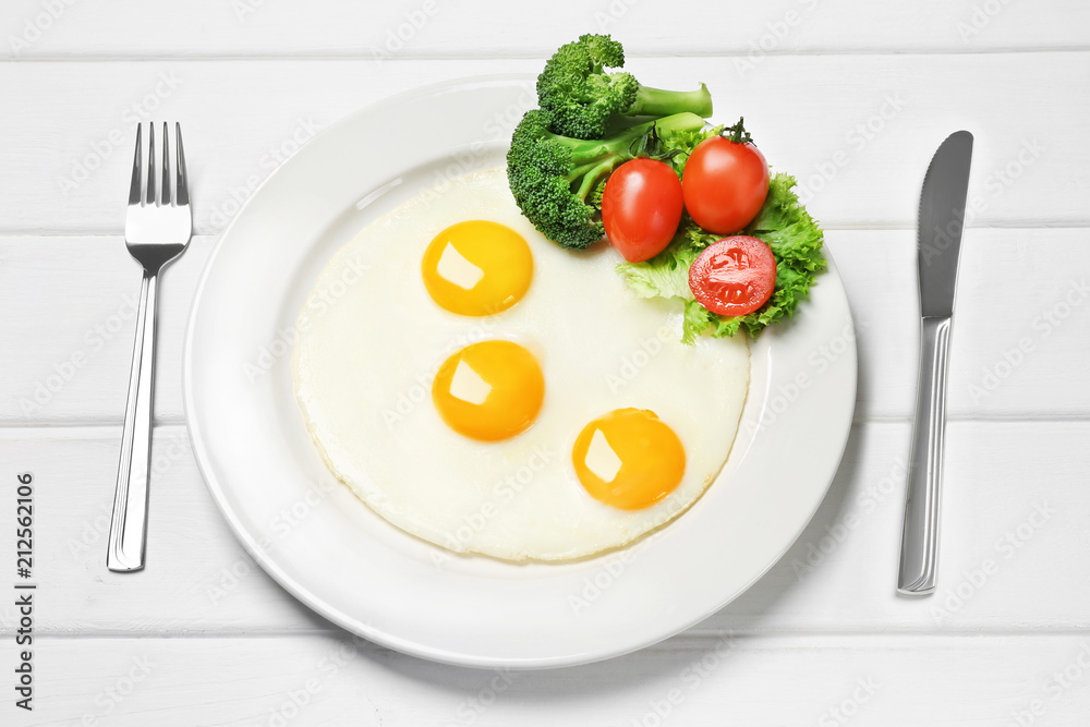 fried eggs with fresh vegetables on the table fried eggs with fresh vegetables on the table
