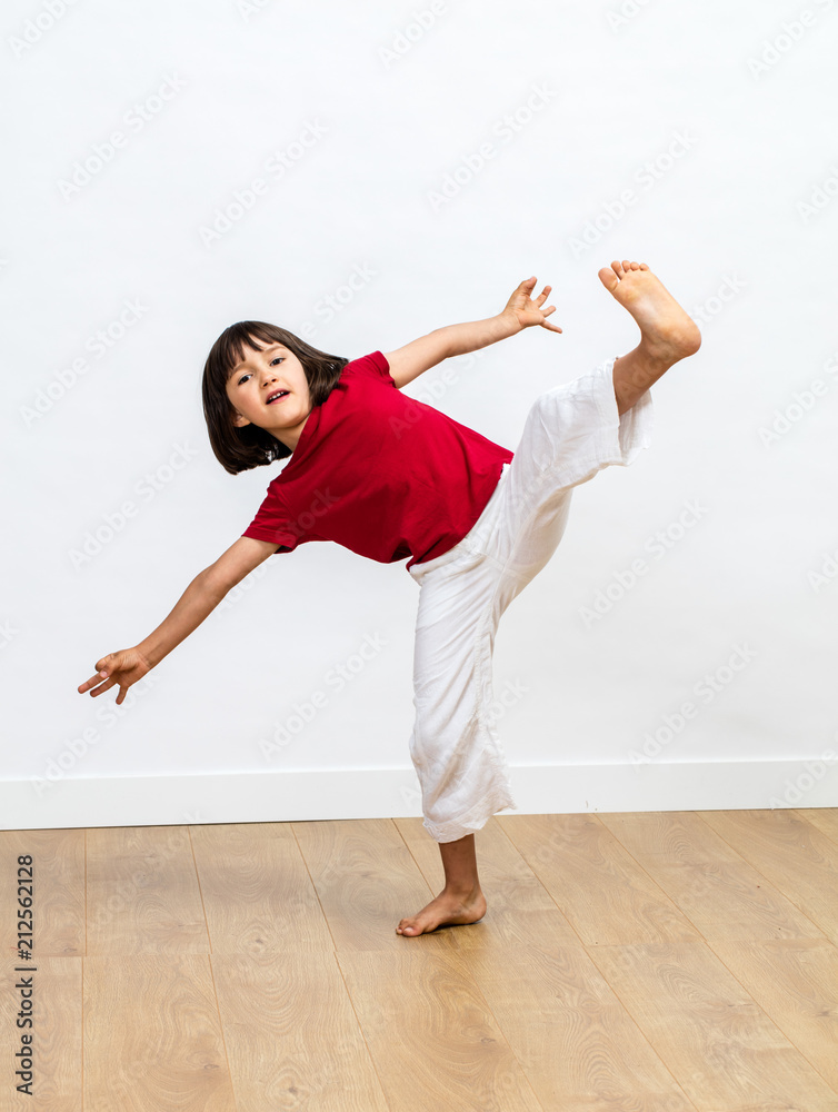 dynamic child enjoying fighting tai chi, kung fu or taekwondo