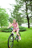 Girl riding her bicycle in the park  feeling good 