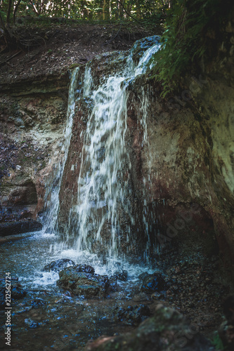 Dauda waterfall in dry summer .Small waterfall in Gauja national park. Latvia. Soft focus.Close up.