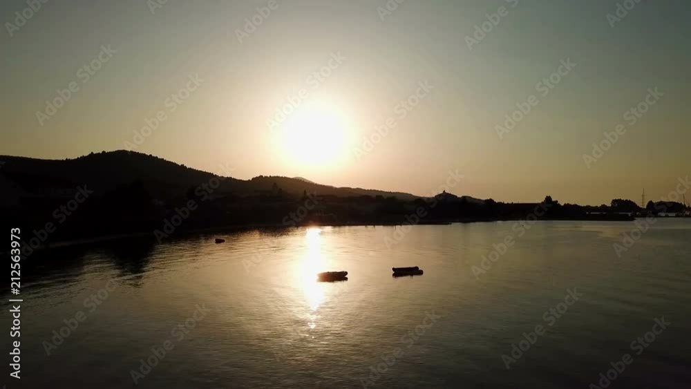 Aerial: drone going down in front of beautiful sunset by the sea. Shot on sea vacation at Croatian Adriatic on island Pasman. Aerial: drone going down in front of beautiful sunset by the sea. Shot on sea vacation at Croatian Adriatic on island Pasman.