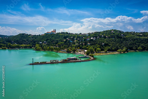 Tihany, Hungary - The harbor of Tihany by Lake Balaton with the famous Benedictine Monastery of Tihany (Tihany Abbey, Tihanyi Apátság) at background with beautiful turquoise water