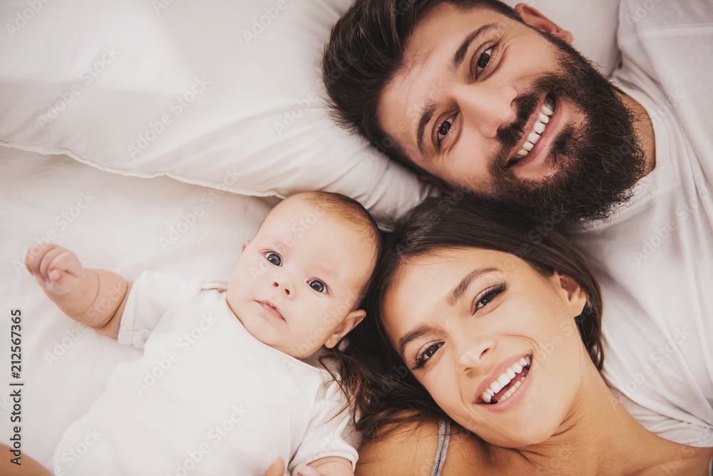 Top view. Mother and Father with Baby in Bed. Top view. Mother and Father with Baby in Bed.