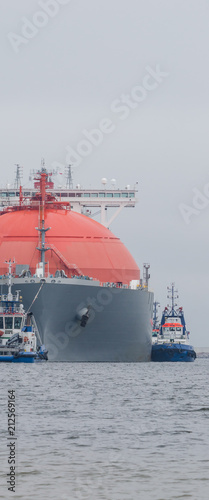GAS CARRIER - A great tanker towed by a tugboat
