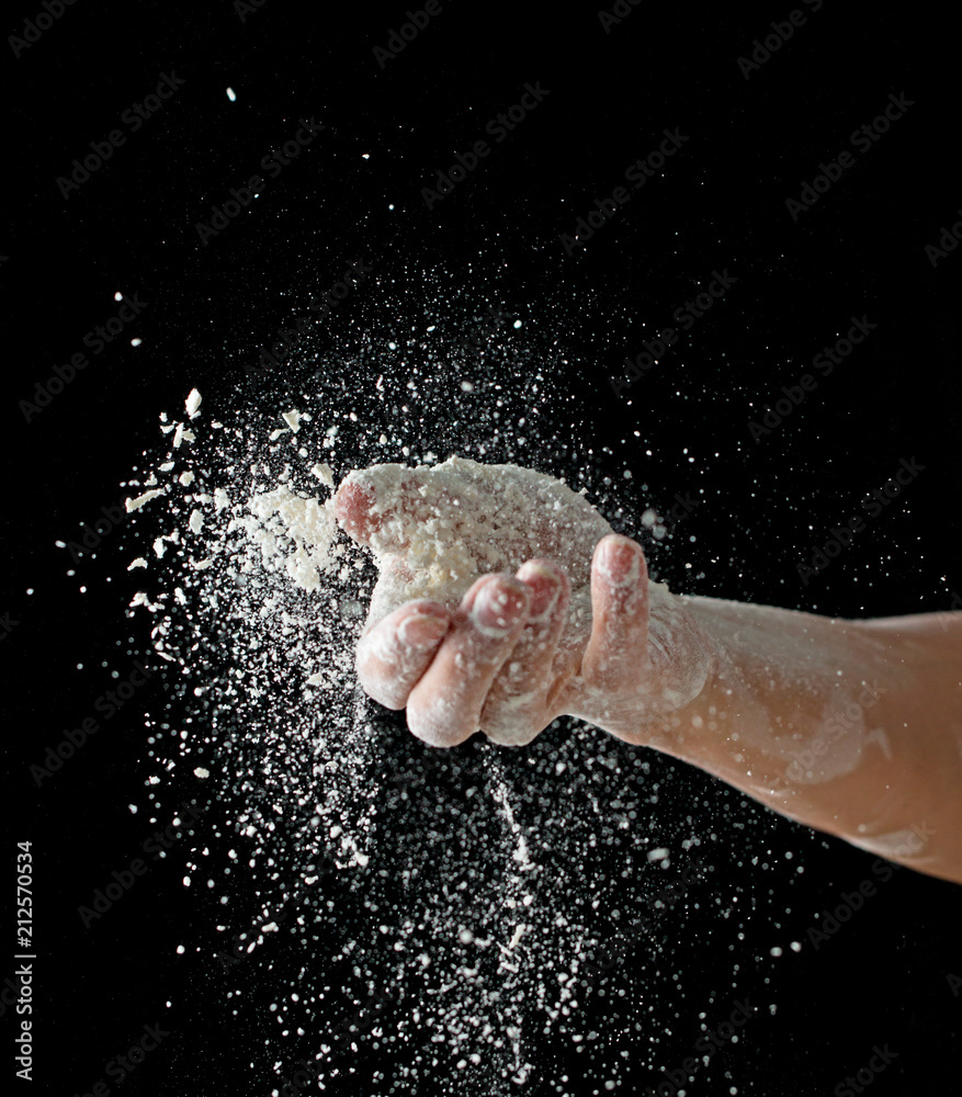 hand with flour on a black background