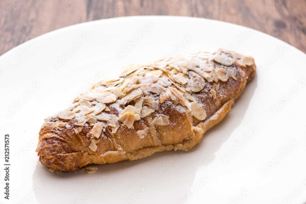Almond croissant filled with almond cream and topped with sliced almonds Almond croissant filled with almond cream and topped with sliced almonds