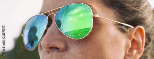 Girl with pilot sunglasses on the beach with reflection, panorama photo