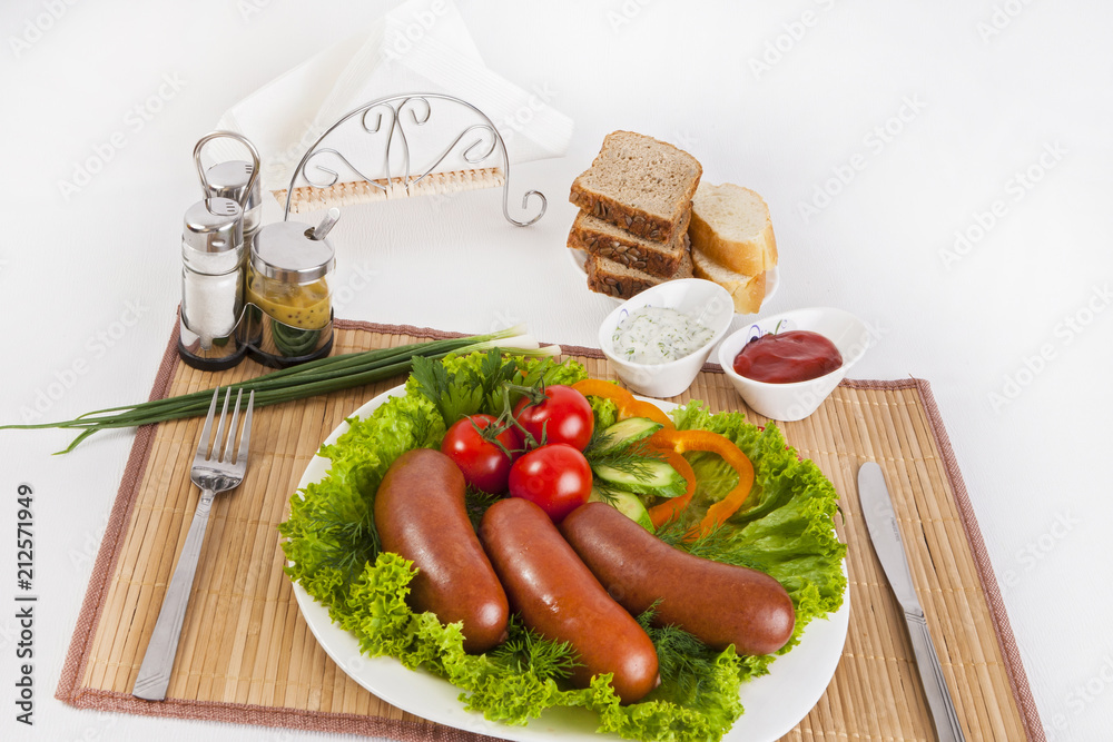 Boiled sausages with tomatoes, cucumbers and greens. Served with black or white bread. Boiled sausages with tomatoes, cucumbers and greens. Served with black or white bread.