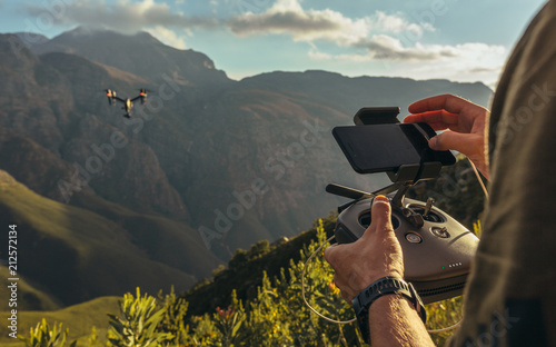Nature photographer flying a drone in mountains