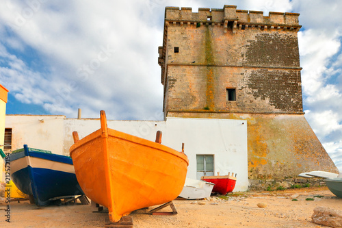 Typical coast village of Salento, with fishing boats and old tower, Apulia, Italy