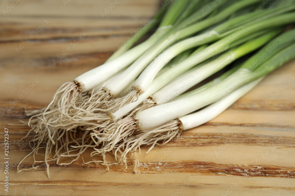 Fresh green onion on wooden table, closeup Fresh green onion on wooden table, closeup