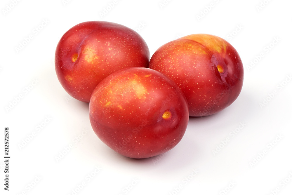 Ripe sweet red plums, isolated on white background. Close-up. Ripe sweet red plums, isolated on white background. Close-up.