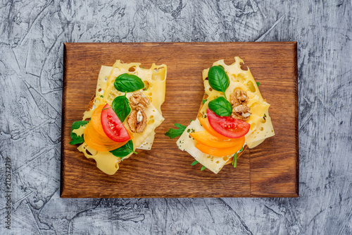 Tomato and basil summer sandwich on kitchen board photo