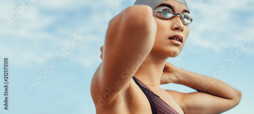 Female swimmer in swim cap and googles