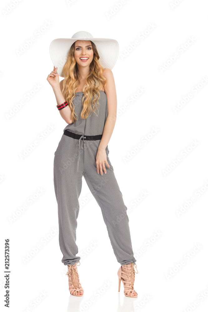 Beautiful Young Woman In Jumpsuit, Sun Hat And High Heels. Full Length. Beautiful Young Woman In Jumpsuit, Sun Hat And High Heels. Full Length.