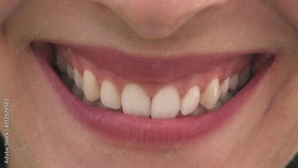Female mouth with beautiful lips and white teeth smiling Female mouth with beautiful lips and white teeth smiling