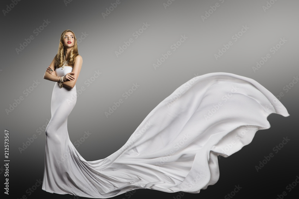 Fototapeta premium Woman White Dress, Fashion Model in Long Silk Sexy Gown, Waving Tail Flying Fabric Train, Cloth Fluttering on Wind