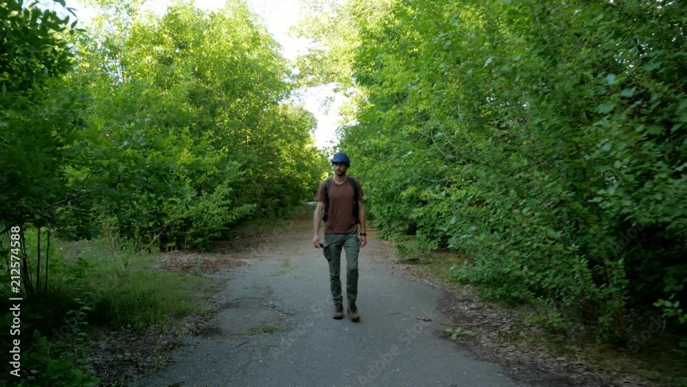 Tourist travels in the depth of forest on the road Tourist travels in the depth of forest on the road