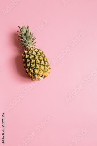 Ripe pineapple on pastel pink background isolated. Minimalist style trendy tropical concept. Room for text, copy, lettering.