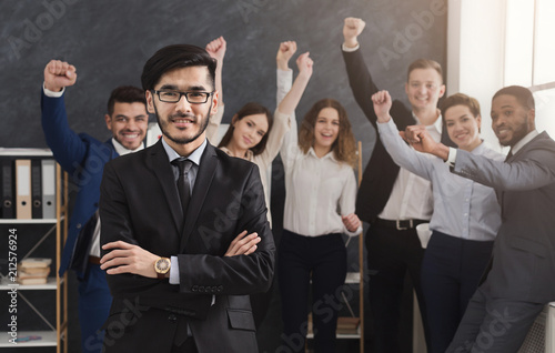 Confident business team standing in office